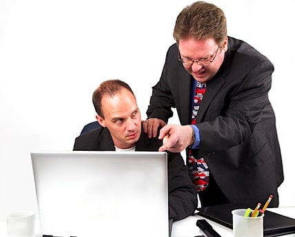 a boss micromanaging an employee