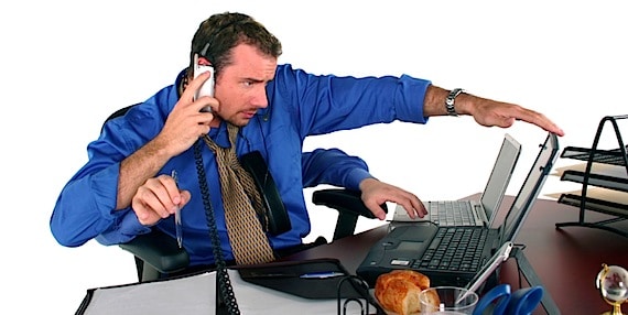 A Very Busy Man Attempting to Multi-Task To Get It All Done - Photo courtesy of ©iStockphoto.com/tzara, Image #250015