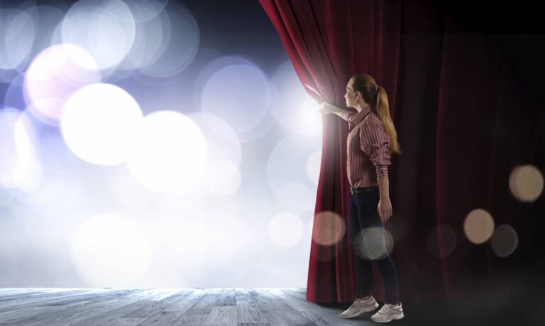Woman opening curtains to reveal light, symbolizing new opportunities with Full Focus for achieving the Double Win.