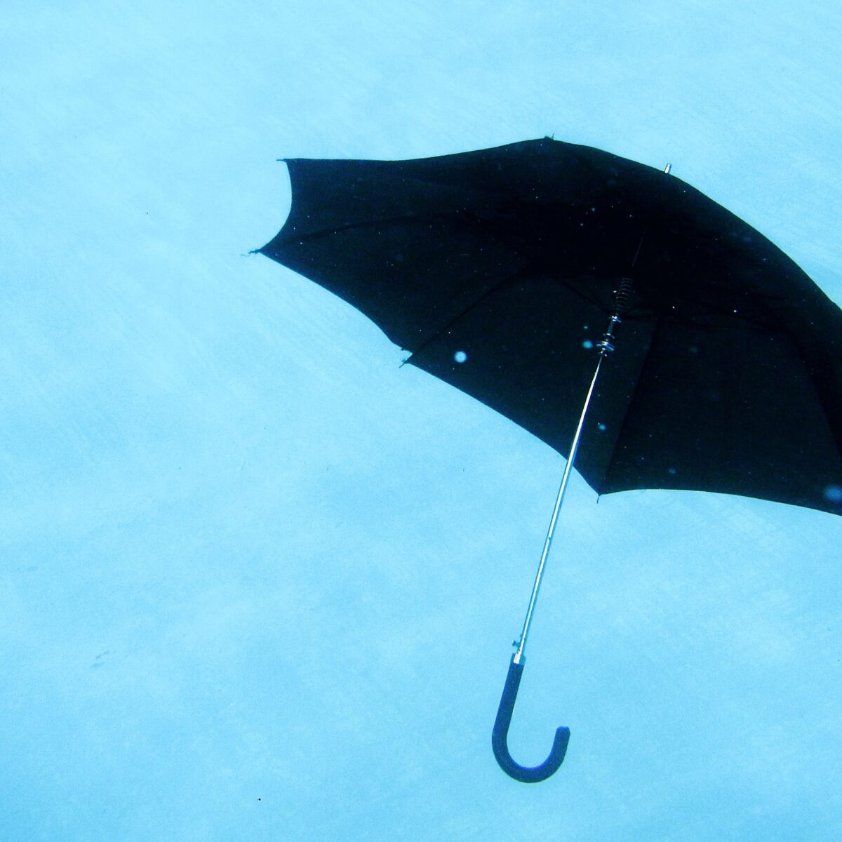 Black umbrella floating, symbolizing balance in productivity and life, aligned with Full Focus's Double Win concept.